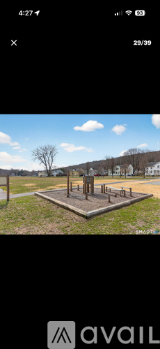 A park with a playground and a statue.
