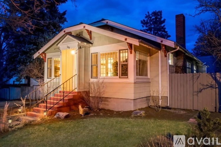 A house with a front porch and a staircase leading to the entrance.