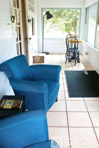 A blue chair is in front of a white wall.