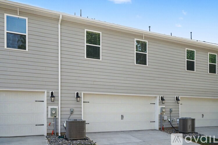 A building with a grey facade and two garages.