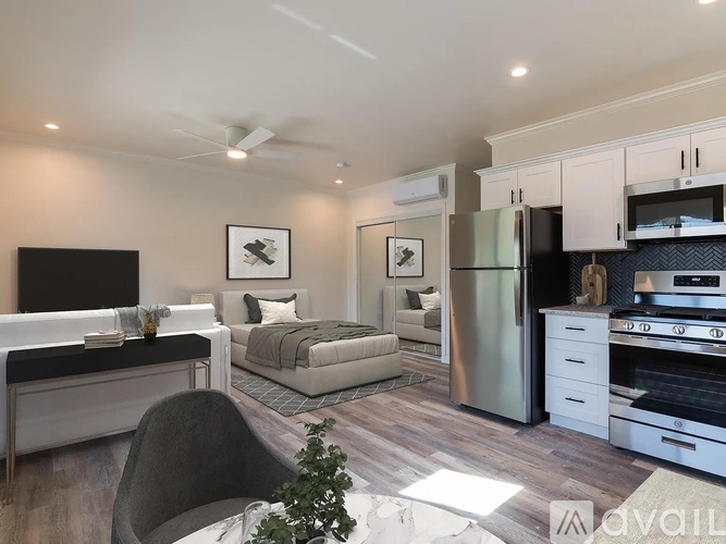 A modern kitchen with a refrigerator, oven, and microwave.