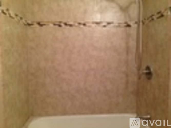 A bathroom with a chain hanging on the wall.