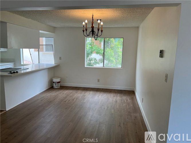 A room with wooden floors and a chandelier.