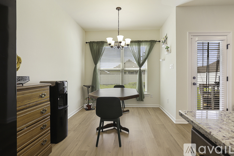 A kitchen with a table and chairs in the middle of the room.