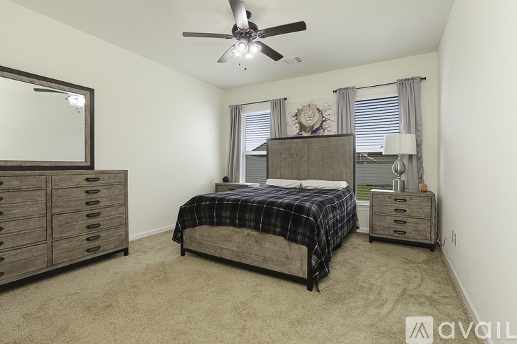 A bedroom with a bed, dresser, and mirror.