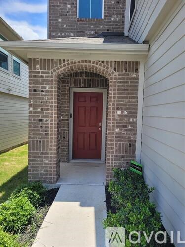 A red door is the centerpiece of this home's front entrance.