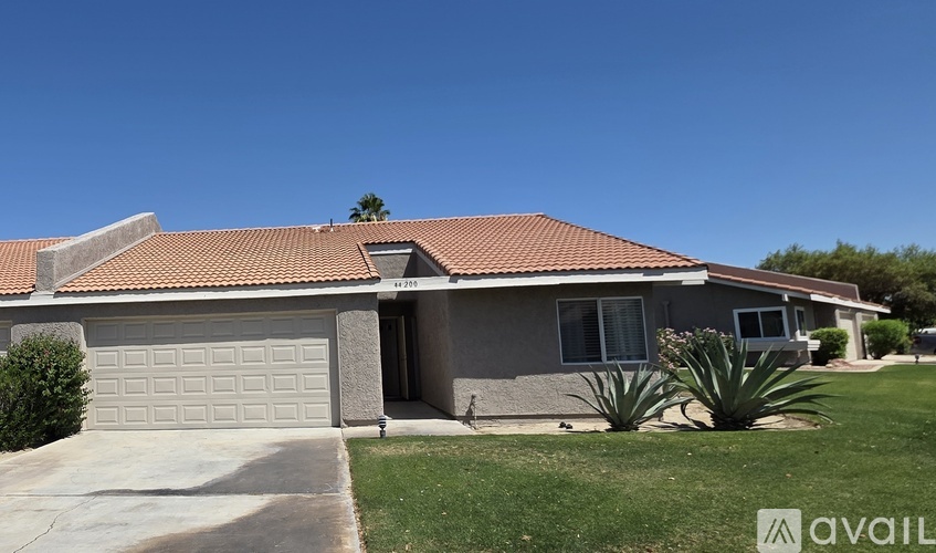 A house with a garage and a driveway is for sale.