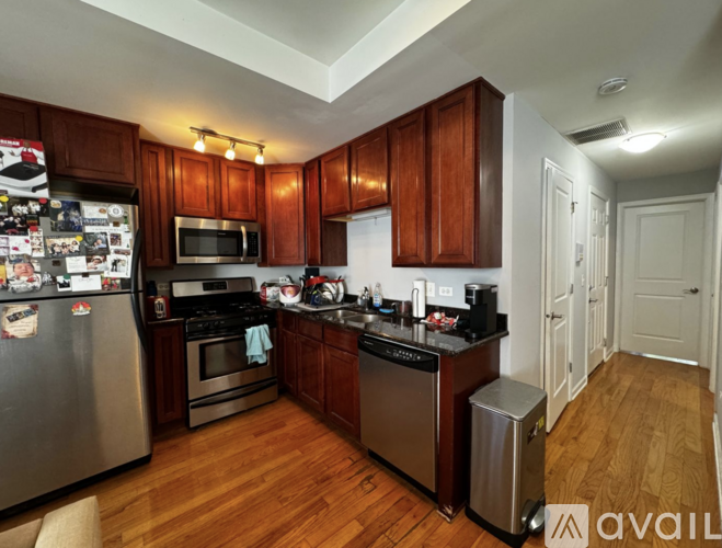 A kitchen with wooden cabinets and stainless steel appliances.