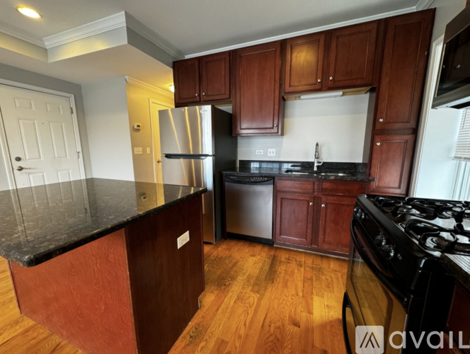 A kitchen with wooden cabinets and black appliances.