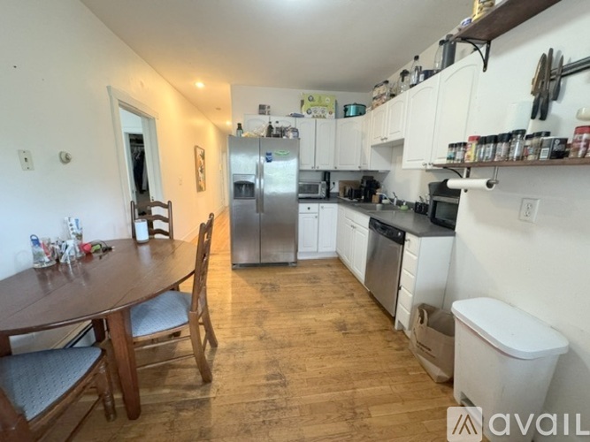 A kitchen with a table and chairs in the middle of the room.
