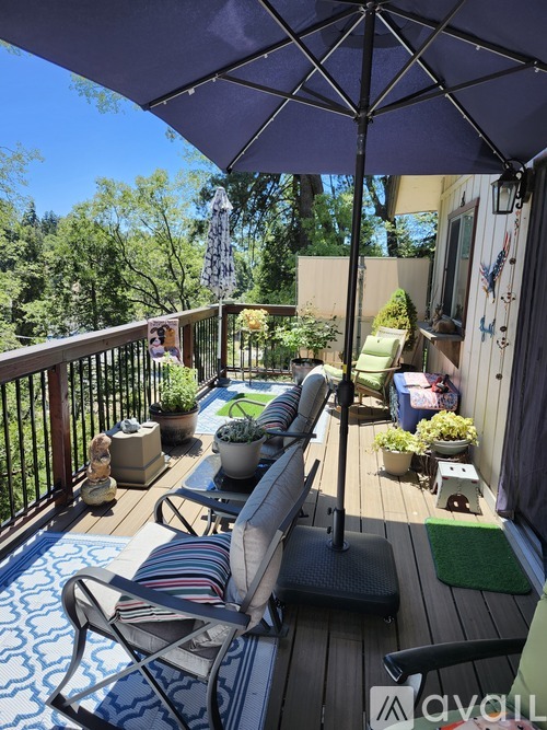 A patio with a striped chair and a striped cushion on it.