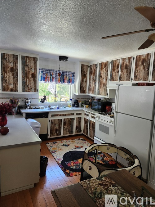A kitchen with wooden cabinets and a white fridge.