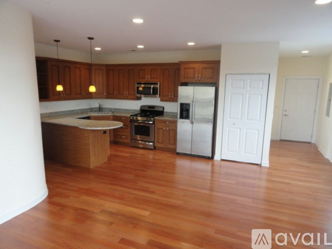 A kitchen with wooden cabinets and a white fridge.