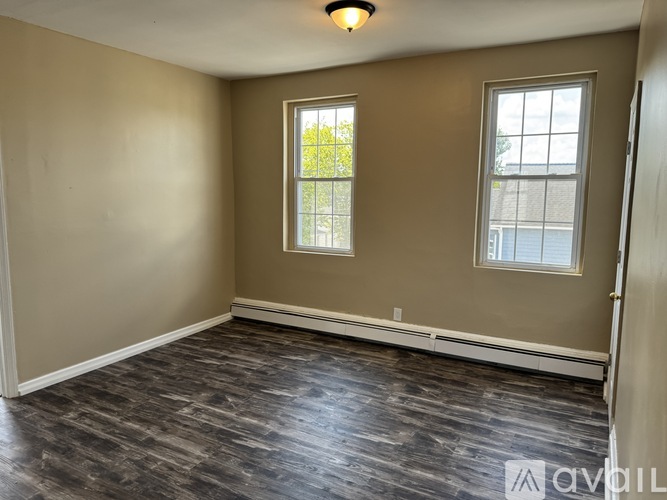 A room with a window and a door.