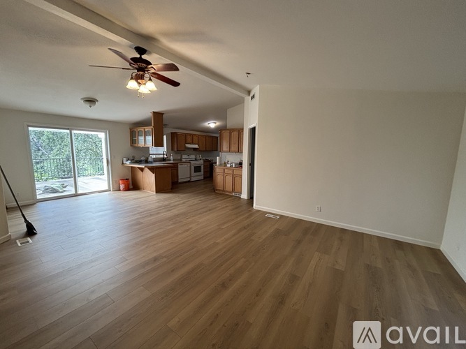 A room with wooden floors and a ceiling fan.