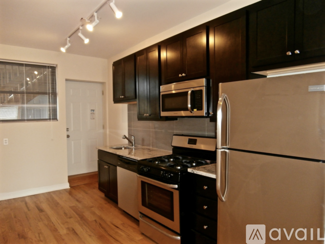 A kitchen with black cabinets and stainless steel appliances.
