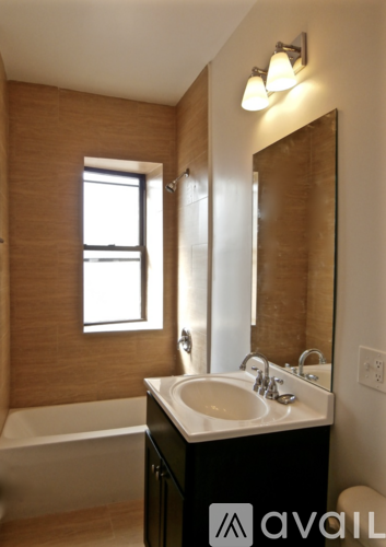 A bathroom with a sink, mirror, and tub.