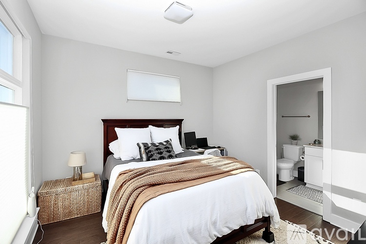 A bedroom with a large bed and a window.