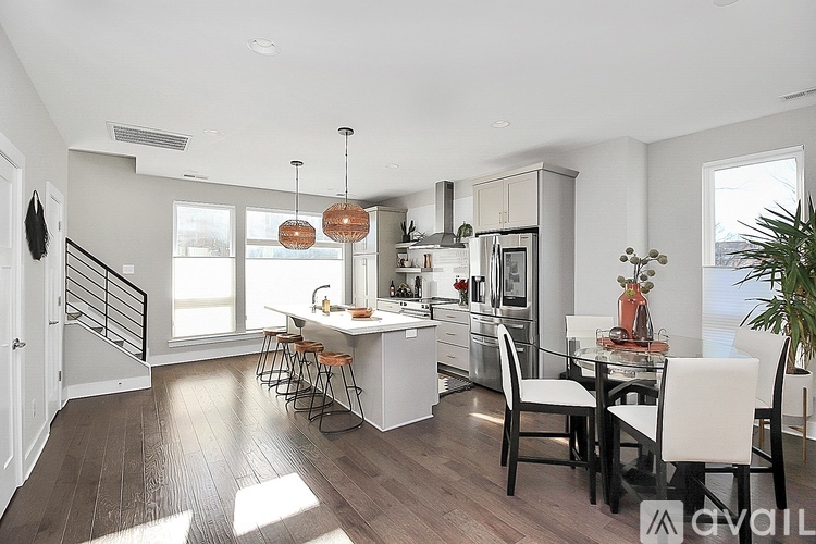 A modern kitchen with a dining table and chairs.