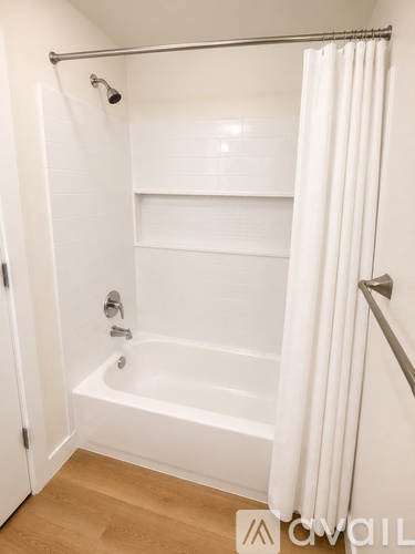 A white bathroom with a tub and a shower.