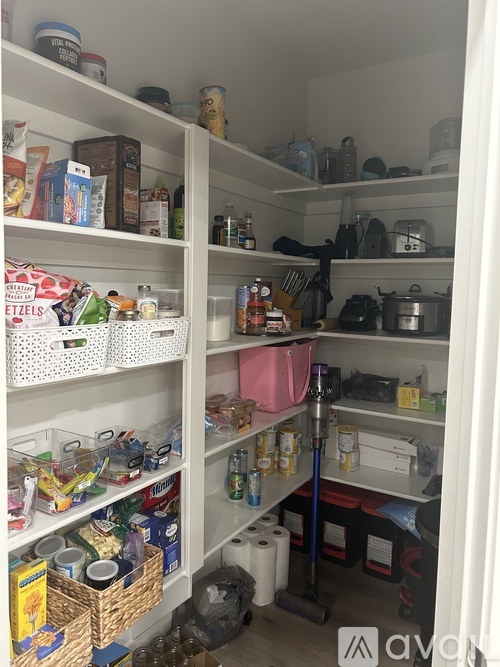 A kitchen pantry with white shelves and a variety of food items and containers.