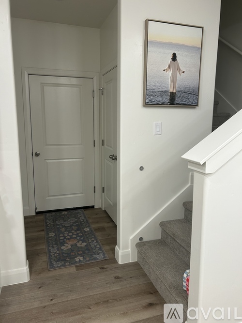 A hallway with a picture of a person standing in water hanging on the wall.
