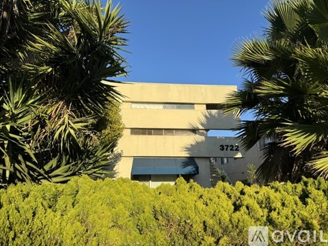 A building with the number 3722 on it is surrounded by greenery.