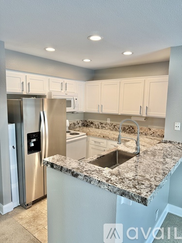 A kitchen with granite countertops and stainless steel appliances.