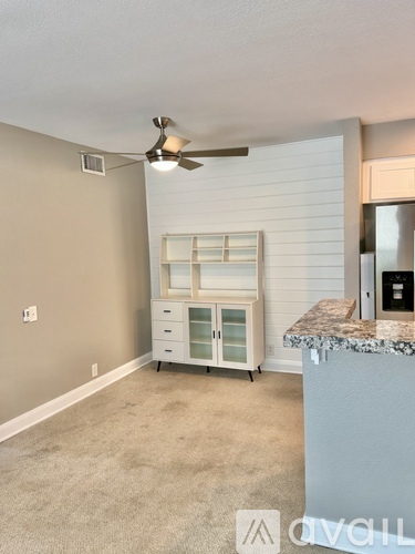 A kitchen area with a fan, a drawer, and a counter.