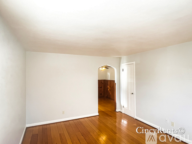 A room with wooden floors and white walls.