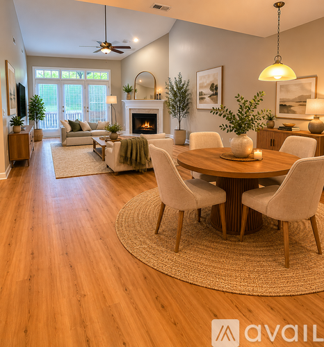 A living room with a wooden floor and a fireplace.