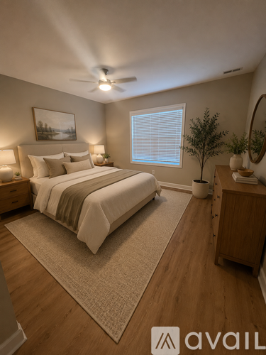 A bedroom with a large bed and a ceiling fan.