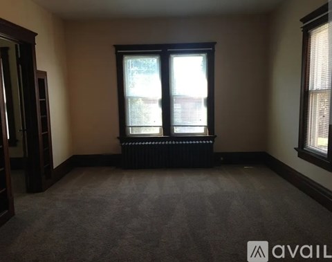 A room with a large window and a radiator on the floor.