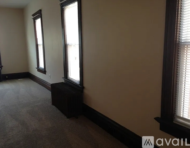 A room with a window and a bench.