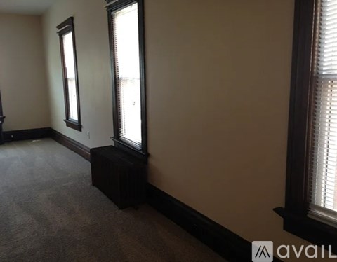 A room with a window and a bench.