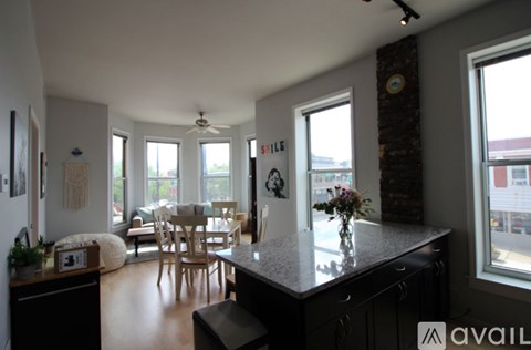 A kitchen with a table and chairs in the middle of the room.