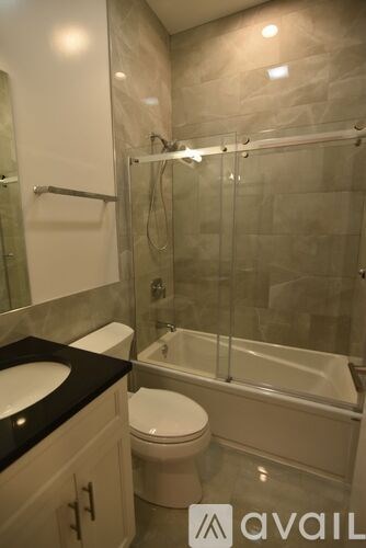 A bathroom with a toilet, sink, and bathtub.