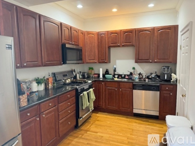 A kitchen with wooden cabinets and stainless steel appliances.