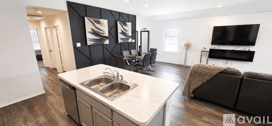 A modern kitchen with a sink and a couch.