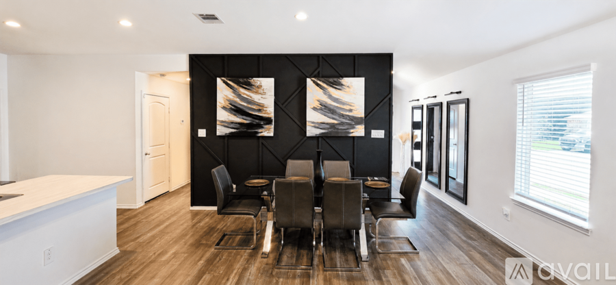 A modern dining room with a large table and chairs.