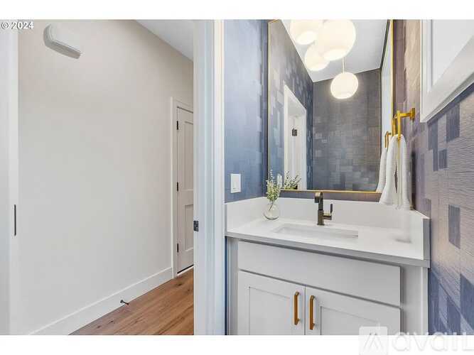 A bathroom with a white sink and a mirror.