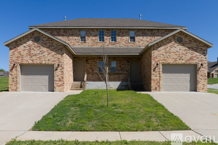 A two-story brick house with a garage on each floor.