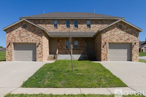 A two-story brick house with a garage on each floor.