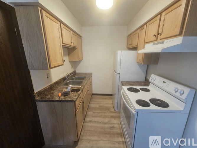 A kitchen with wooden cabinets and a blue stove.