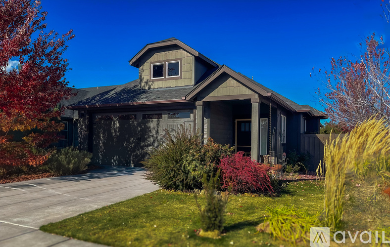 A house with a grey roof and a grey front yard.