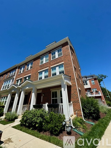 A red brick building with white columns in front.