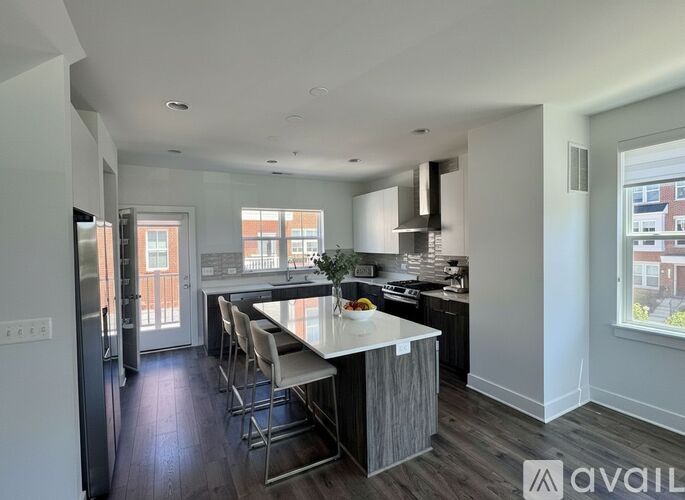 A modern kitchen with a dining table and chairs.