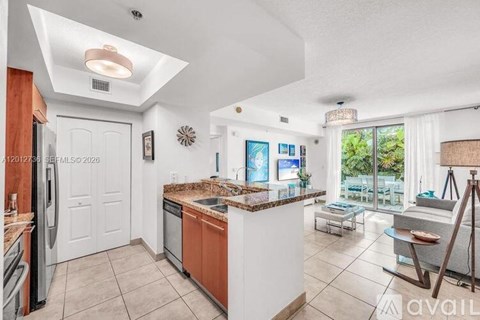 A kitchen with a refrigerator, sink, and a window.