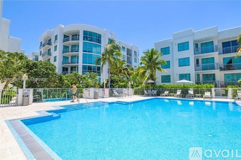 A swimming pool in front of a building with the word "available" on it.