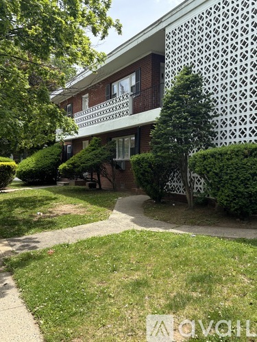 A white building with a lattice design on the side.
